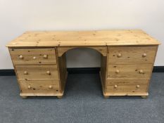 A pine kneehole dressing table fitted six drawers
