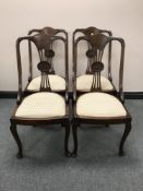A set of four antique mahogany dining chairs on cabriole legs