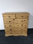 A contemporary pine five drawer chest