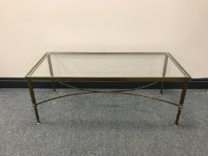 A brass glass topped coffee table