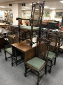 An early twentieth century oak drop leaf barley twist dining table together with a set of five