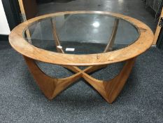A circular teak G Plan glass topped coffee table