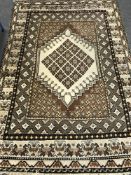 A fringed woollen carpet on cream ground