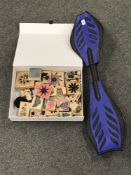 A box containing assorted rubber stamps together with a snake skateboard.