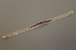 A fine quality ruby and diamond bracelet in 18ct white gold, 52g.