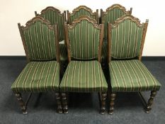 A set of six oak dining chairs upholstered in a green striped fabric