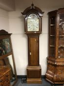 An early 19th century inlaid oak long cased clock with painted moon phase dial, height 238 cm.