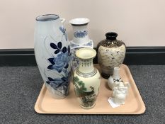 A tray containing six assorted oriental style vases together with a small china figure of Buddha