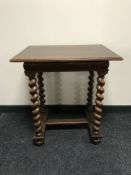 An oak occasional table on barley-twist legs