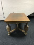 An oak pull out dining table on bulbous legs