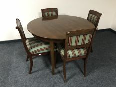 A reproduction circular dining table and four chairs