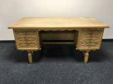 A blond oak twin pedestal desk