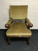 An early 20th century oak armchair in gold dralon