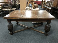 An early 20th century oak pull out table