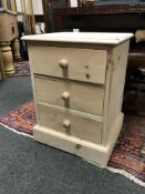 A pine three drawer chest