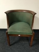 An early 20th century oak tub chair