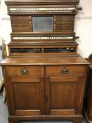 A late Victorian oak snooker score board cabinet, the score board area above cupboard base,