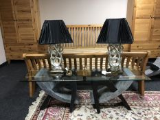 A pair of contemporary glass topped lamp tables and a pair of table lamps