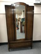 A mid-20th century oak mirror door wardrobe
