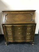 A continental oak bureau fitted with three drawers