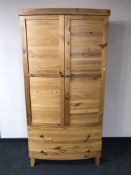 A contemporary plantation pine Seville bow-fronted wardrobe fitted two drawers
