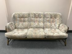 A wood framed Ercol three seater settee