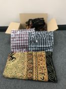 A box containing Pashminas and an embroidered bedspread