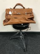 A brown leather velize together with a folding drummer's stool