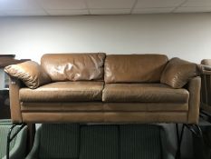 A brown leather settee