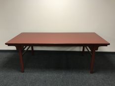 A red lacquered oriental style dining table CONDITION REPORT: This measures 210cm