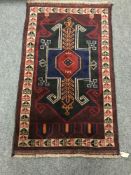 A Baluchi rug on red ground