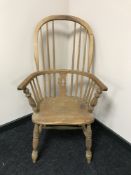 An antique pine kitchen armchair