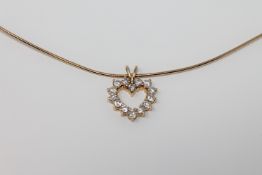 An 18ct gold diamond set heart pendant on chain, the total diamond weight approximately 1.