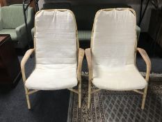 A pair of wicker and bamboo conservatory armchairs