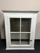 A painted pine glazed door wall cabinet