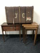 A nest of three mid-20th century teak tables together with a sewing box and a wooden bound trunk