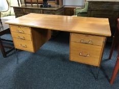 A mid 20th century teak twin pedestal desk