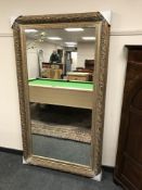 A large contemporary overmantel mirror in gilt frame