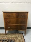 A walnut three drawer chest