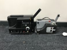 A box of film reels together with a folding music stand and seven cine projectors