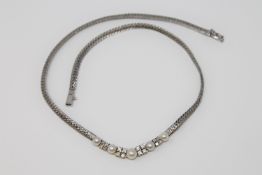 An 18ct white gold necklace set with pearls and diamonds, approximately 0.9ct. 28.