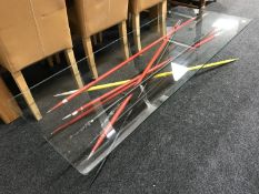 A contemporary rectangular glass-topped coffee table on metal base CONDITION REPORT: