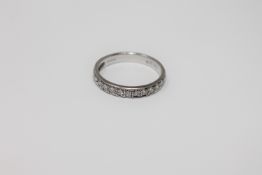 An 18ct white gold diamond half eternity ring,
