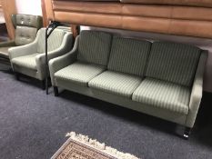 A late twentieth century three seater settee and armchair upholstered in green striped fabric