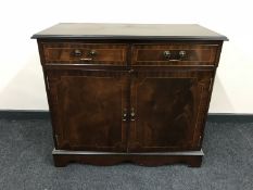 An inlaid mahogany double door cupboard fitted two drawers