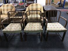 A set of three oak rail backed armchairs