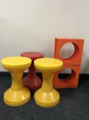 Three circular Danish plastic stools together with two orange plastic record stands