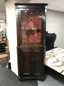 An antique pine corner cupboard