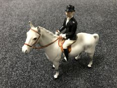 A Beswick figure - huntswoman on a horse, grey in a gloss finish.