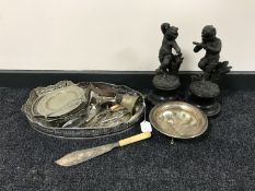 An oval plated tray containing assorted plated cutlery,